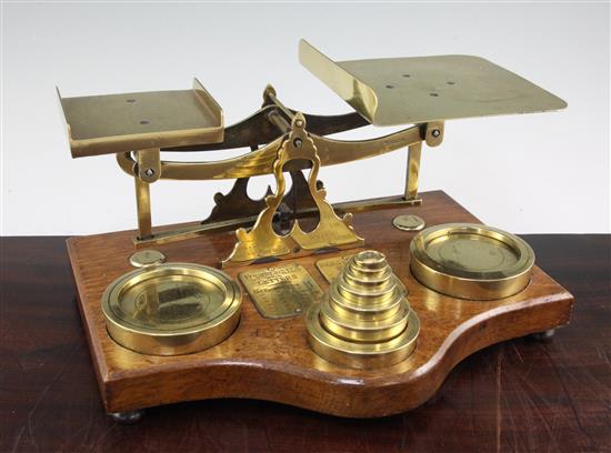 A set of Victorian brass and oak postal scales, 16in.